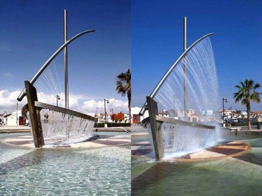 Đài phun nước Water Boat tạo hình con thuyền độc đáo giữa không gian đô thị Tây Ban Nha. Công trình gây ấn tượng mạnh nhờ thiết kế như một con thuyền đang lướt trên mặt nước. Dòng nước chảy tràn quanh thân thuyền tạo hiệu ứng chuyển động mềm mại, mang đến cảm giác vừa lạ mắt vừa nghệ thuật.